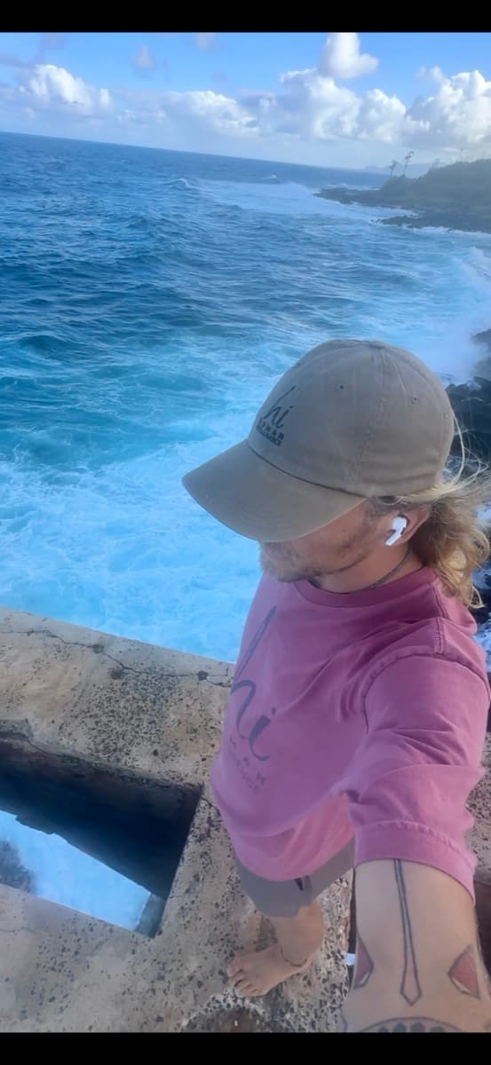 Alex wearing HI gear at the ocean overlook, Kauai, HI
